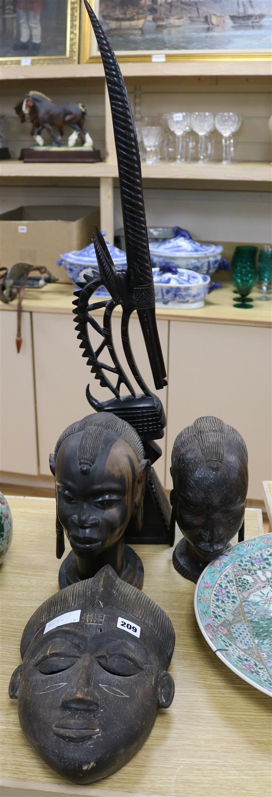 An African mask, two carved African heads and a Mali headdress, all 20th century (4) mask width 20cm height 32cm